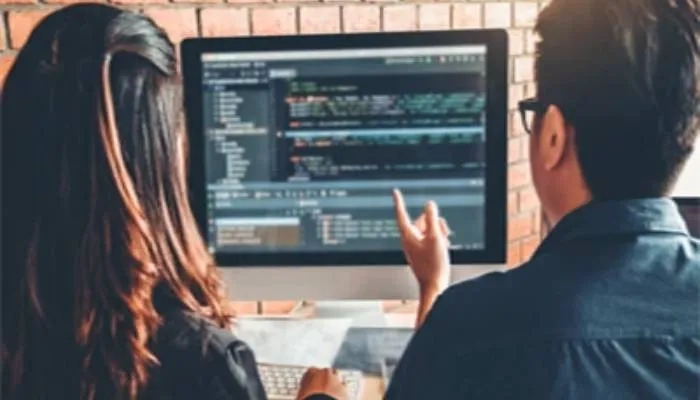Two people looking at computer screen